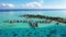 Travel vacation paradise aerial video with overwater bungalows in coral reef sea