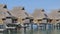 Travel vacation paradise with overwater bungalow resort hotel in coral reef sea