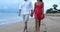 Travel vacation romantic couple holding hands walking on beach at night