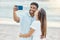 Travel, vacation and selfie by couple kiss on a beach holiday, bonding and having fun on seaside getaway. Young man and