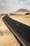 Travel and vehicle long black asphalt road with nature wild outdoor desert around - alternative journey with car and no traffic on