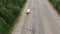 Travel white bus driving on autobahn through the woods White bus fast speed moving on two sided highway. Aerial drone