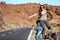 Travel woman hitchhiking on road trip