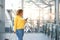 Travel woman looking at mobile phone at station