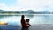 Travel Woman Sitting on Wooden Pier with Laptop, Relaxing and Enjoying Nature