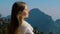 Travel woman standing on top of mountain, enjoying view at sunrise