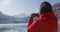 Travel woman taking photo on phone of Glacier Bay Alaska cruise ship passenger