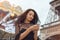 Travel woman using smartphone near the Eiffel tower and carousel, Paris.