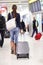Travel woman walking in an airport with luggage