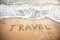 Travel word on the beach