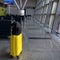 Travel yellow suitcase with black backpack at the empty airport