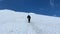 Traveler_3Two climbers walk in a bundle up Mount Elbrus. Aerial view of a beautiful mountain winter landscape.