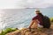 Traveler asia woman sitting on sea cliff