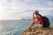 Traveler asia woman sitting on sea cliff