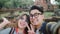 Traveler Asian couple using smartphone taking selfie while spending holiday trip at Ayutthaya, Thailand, Couple enjoy their