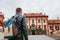 A traveler with a backpack looks at the tourist attraction. The tourist looks at the castle in the Czech Republic