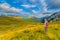 Traveler with backpack and mountain panorama. Summer mountaine landscape with cloudy sky. Mountain scenery, National park Durmitor