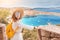 Traveler with backpack at the observation point on top of the old castle with great view on mediterranean sea