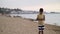 Traveler boy walk on the beach and using smart phone in the evening, chats, write sms. Using a portable handheld device