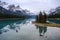 Traveler canoeing in Canadian rockies reflection on Maligne lake at Spirit island in Jasper national park