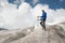 Traveler in a cap and sunglasses standing in the snowy mountains on the glacier. Traveler in a natural environment