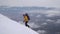 A traveler climbs the snowy slope of the mountain