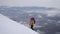 A traveler climbs the snowy slope of the mountain