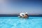 Traveler couple in a infinity pool enjoying the Mediterranean sea