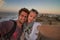 Traveler couple taking selfie on city fortress wall of Essaouira, Morocco.