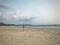 A traveler on a deserted beach.