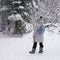 Traveler-explorer woman discovering the winter wonders of the forest nature