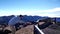 Traveler feeds a large black bird on the mountain `Roque de los Muchachos` on La Palma, Canary islands