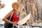 Traveler girl in Barcelona in front of Sagrada Familia. Woman tourist hold and look map, concept adventure