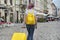 Traveler girl walking with backpack and suitcase, back view