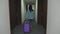 Traveler girl walking with suitcase at hotel hallway.