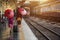 Traveler girl walking and waits train on railway platform