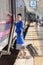 Traveler girl walking and waits train on railway platform