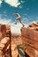 Traveler jumps over rock at Horseshoe Bend , USA