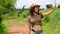 traveler makes a photo on the phone against the backdrop of a tall giraffe