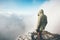 Traveler man alone on mountain summit over clouds