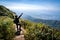 Traveler man embracing nature with opening arms in the middle of abundance natural forest in the mountain