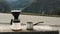 Traveler man making filter coffee and pours water in ground coffee beans against mountain view