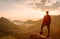 Traveler man standing on top of rock in the mountains.