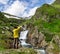 Traveler man taking photo of big waterfall in Georgia