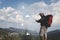 Traveler Man use technology with backpack mountains landscape on background