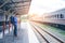 Traveler man waits train on railway platform