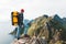 Traveler man wearing backpack and red hat climb on high mountains above sea