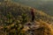 Traveler in the mountains. A man enjoys a beautiful view of the mountains. Man at sunrise in the mountains.