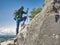 Traveler in the mountains stands on a rock