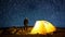 Traveler near the glowing camping tent on the background of the star circles in the night sky. Cinemagraph and Time-lapse.